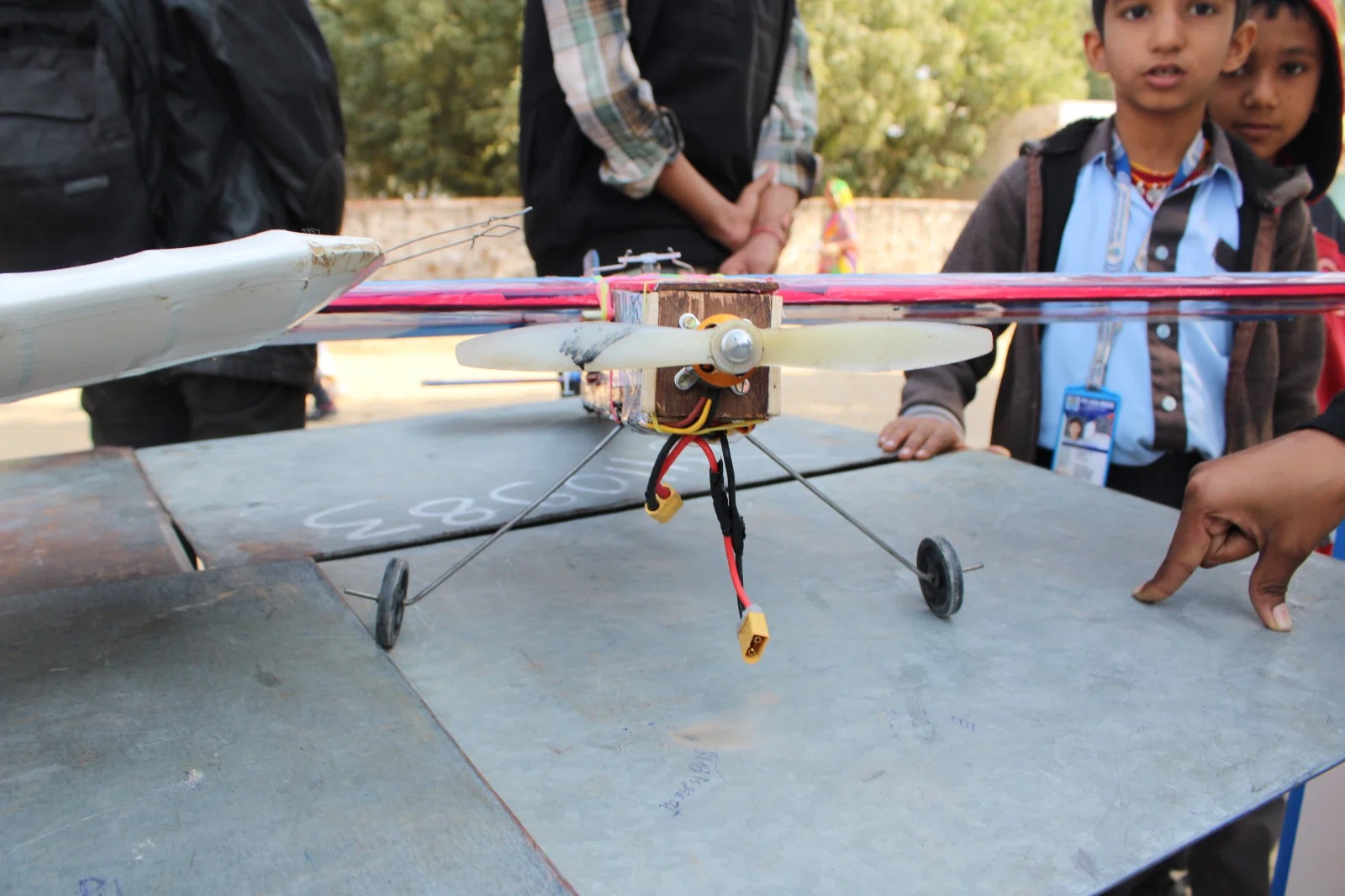Students examining a model aircraft up close