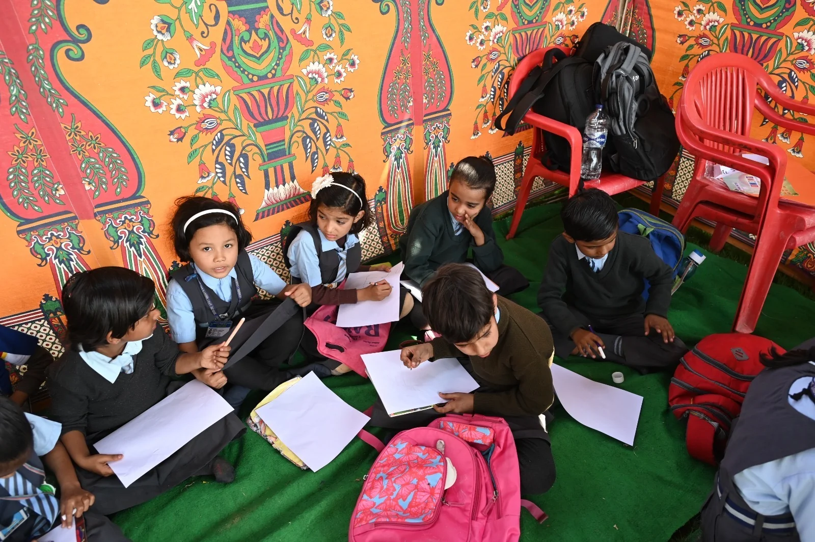Students drawing together at an activity stall