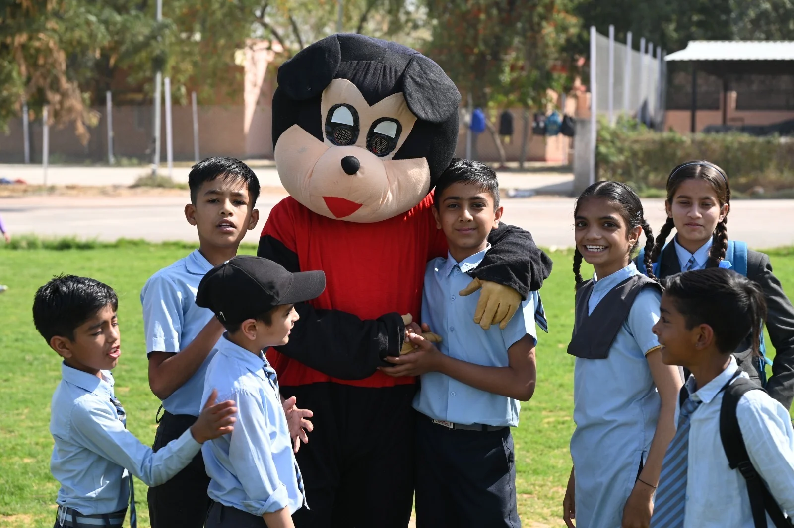 Children enjoying a visit from a costumed mascot